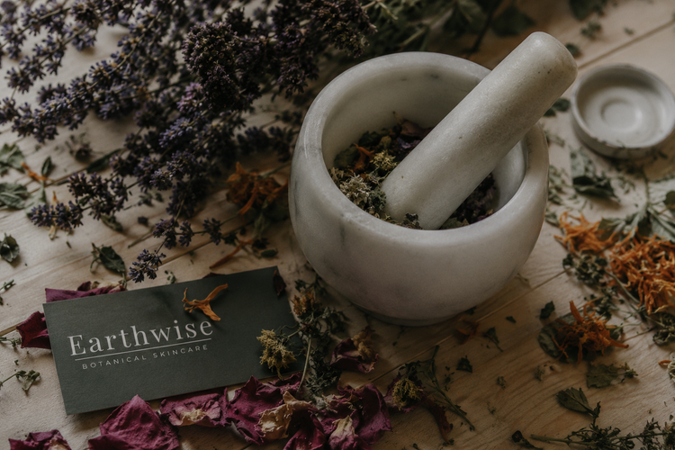 Mortal and postal rounded by dried herbs with Earthwise logo