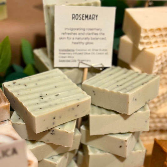 Stack of rosemary soap bars with a descriptive card in the background