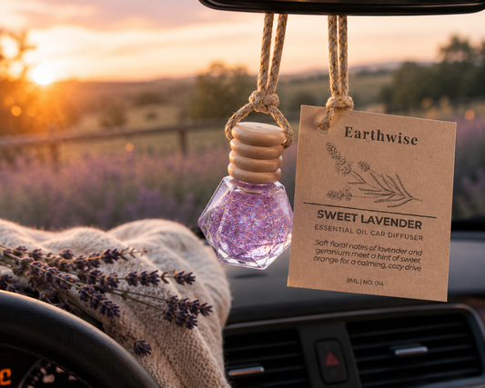 Earthwise Sweet Lavender essential oil car diffuser hanging from a car's rearview mirror with a scenic background.