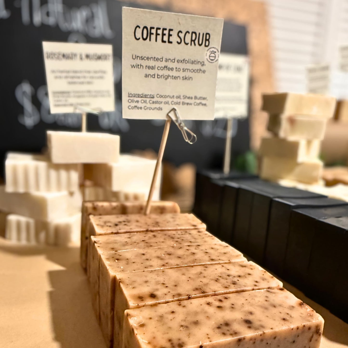 Coffee scrub bars with a sign indicating they are unscented and exfoliating.