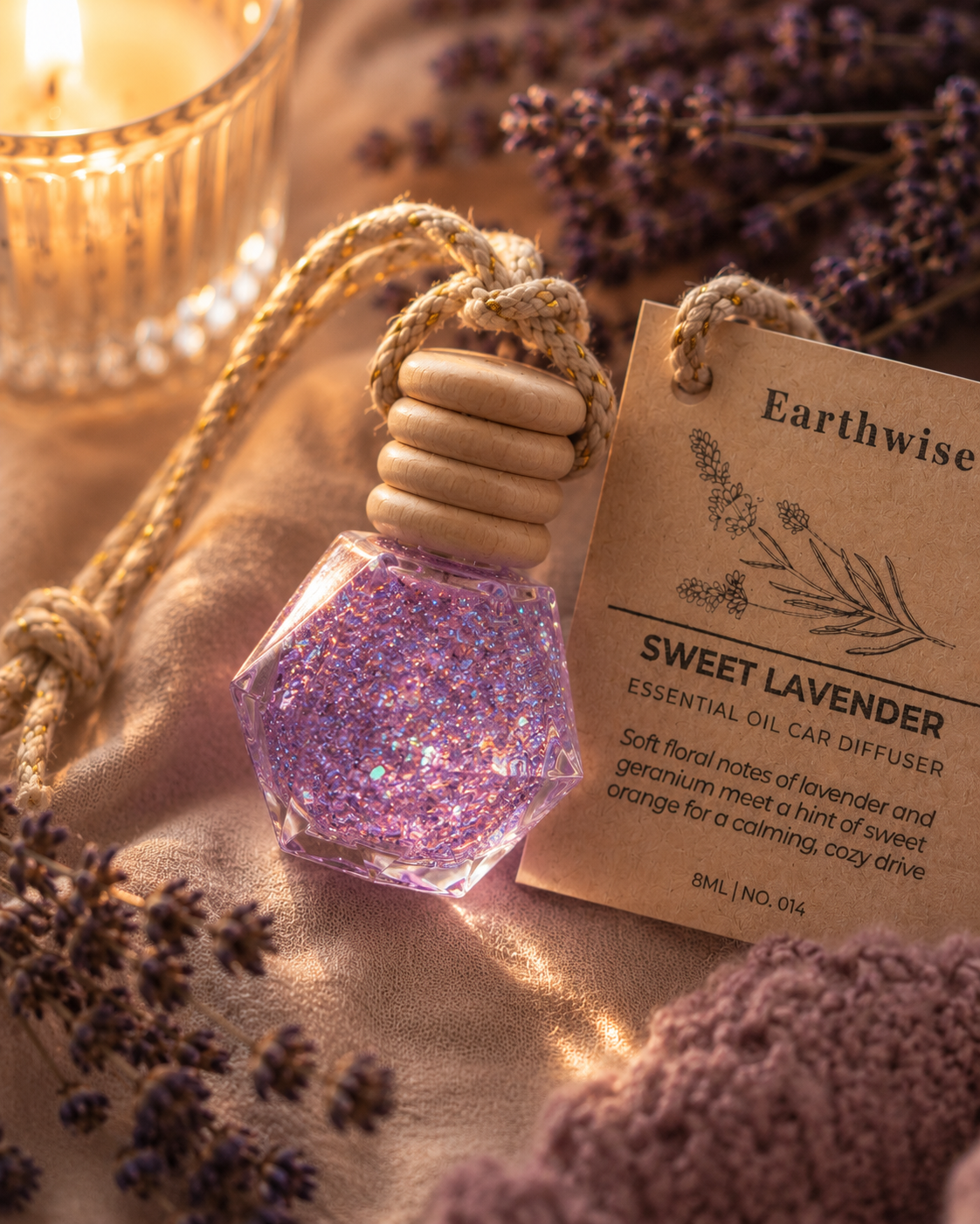 Earthwise Sweet Lavender essential oil diffuser with lavender flowers and a candle in the background