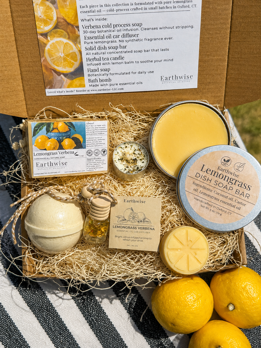 Ariel view of a lemongrass gift box set next to fresh lemons on a sunny porch
