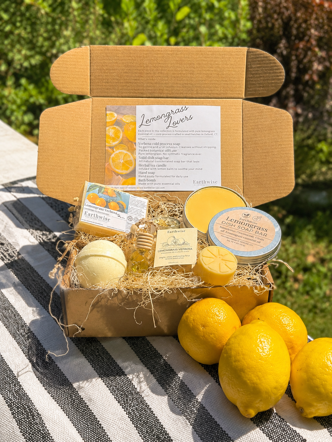 Picture of a lemongrass gift set outside in natural light next to fresh lemons