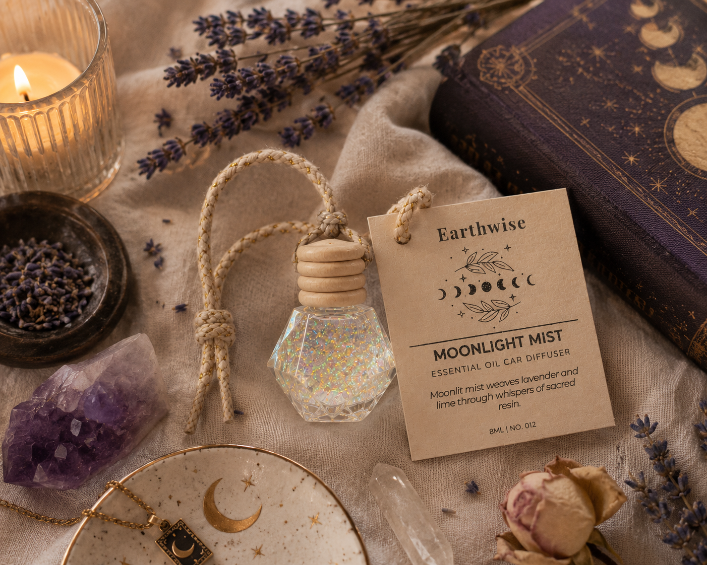 Earthwise Moonlight Mist essential oil car diffuser with lavender, candle, and crystal on a textured surface.