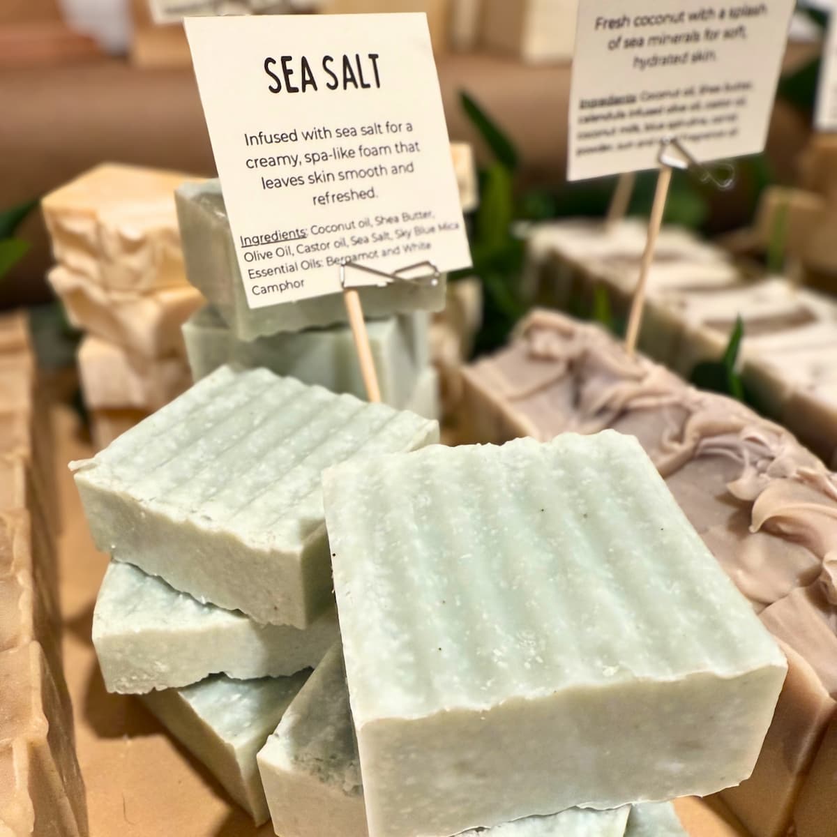 Sea salt soap bars with a label on a wooden surface