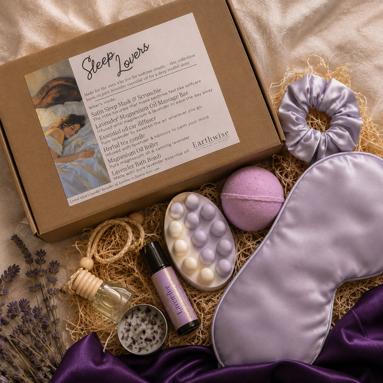 Lavender gift set laid out on purple satin sheets including magnesium oil roller, lavender magnesium massage bar and purple satin sleep mask